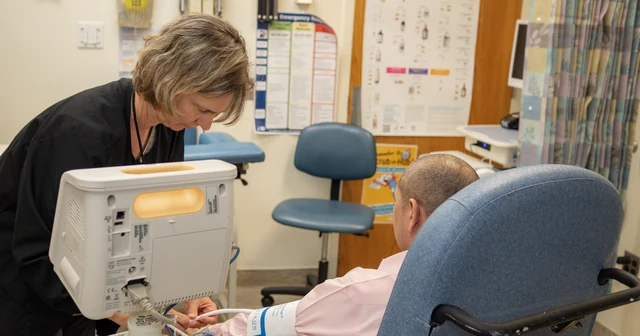 A nurse checks the vital signs of a clinical trial volunteer at the NIH Clinical Center.